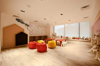 a room with three bean bags in a room with a fireplace at 1BR Paragon Tower Burj Khalifa & Canal Views in Dubai
