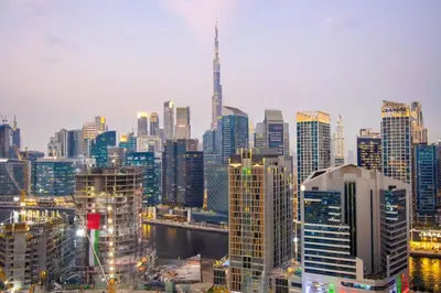 a city skyline with a lot of tall buildings at 1BR Paragon Tower Burj Khalifa & Canal Views in Dubai