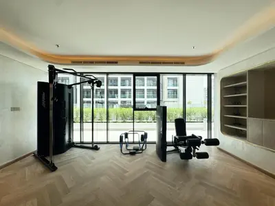 a gym with a treadmill and a chair in a room at Modern & Elegant Studio Apartment in Azizi Riviera in Dubai