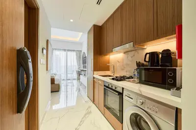 a kitchen with a washer and dryer at Modern & Elegant Studio Apartment in Azizi Riviera in Dubai