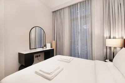 a hotel room with a bed and a mirror at Luxury 4BR Burj Khalifa Opera District in Dubai