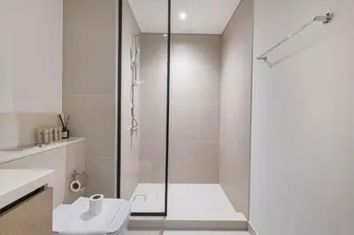 a shower with a glass door in a bathroom at Luxury 4BR Burj Khalifa Opera District in Dubai