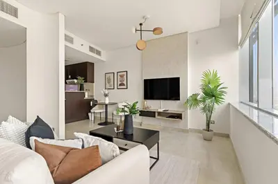 a living room with a couch and a tv at Silkhaus Modern Studio in Sky Gardens Tower DIFC in Dubai