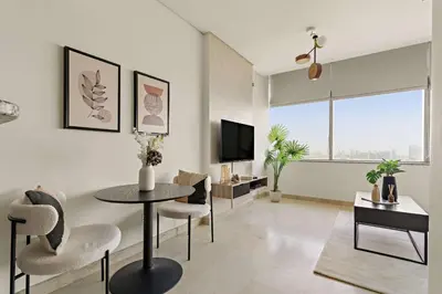 a living room with a table and chairs and a tv at Silkhaus Modern Studio in Sky Gardens Tower DIFC in Dubai