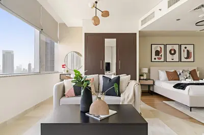 a living room with a couch and a bed at Silkhaus Modern Studio in Sky Gardens Tower DIFC in Dubai