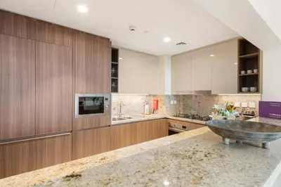 a large kitchen with a large bowl in the middle at Silkhaus Lavish 3BDR+Maid Room Imperial Avenue in Dubai