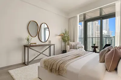 a white bedroom with a large bed and a mirror at Silkhaus Lavish 3BDR+Maid Room Imperial Avenue in Dubai