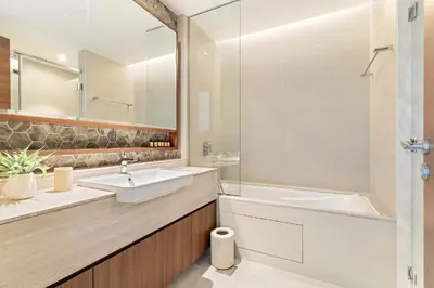 a bathroom with a sink and a mirror at Silkhaus Lavish 3BDR+Maid Room Imperial Avenue in Dubai