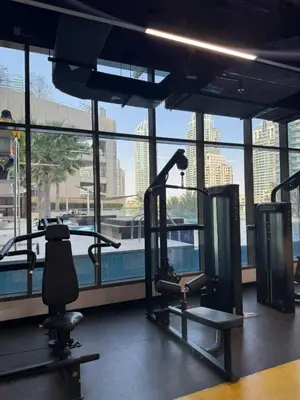 a gym with a view of a large window at Modern 1 bedroom with Direct Marina Access in Dubai