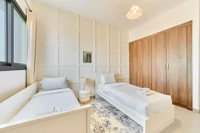a bedroom with two beds and a tub in it at Modern 2BR in Ikarus Tower, Dubai Production City in Dubai