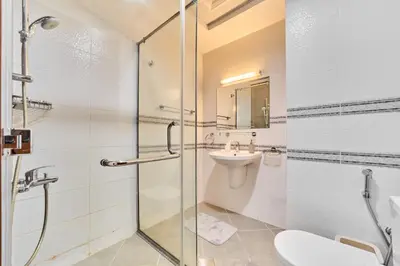 a bathroom with a shower and a sink and a toilet at Modern 2BR in Ikarus Tower, Dubai Production City in Dubai
