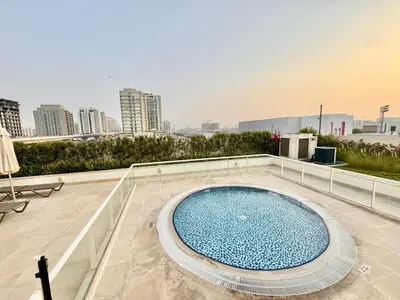 a swimming pool on the roof of a building at Homes2Retreat - Cozy Studio with Pool and Sauna in Al Furjan in Dubai