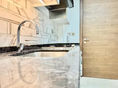 a kitchen with a sink and a counter top at Homes2Retreat - Cozy Studio with Pool and Sauna in Al Furjan in Dubai