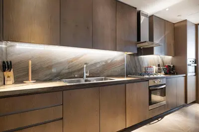 a kitchen with wooden cabinets and a sink at Five Palm Jumeirah Luxury Apartment - 3BR in Dubai