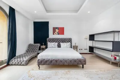 a bedroom with a bed and a chair at Palm Villa F, Palm Jumeirah - Mint Stay in Dubai