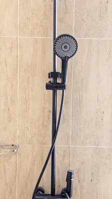 a shower head on a stand in a bathroom at Modern Apartment in Regina Tower JVC - Easy Access to JBR, Circle Mall & Dubai Hills Mall in Dubai