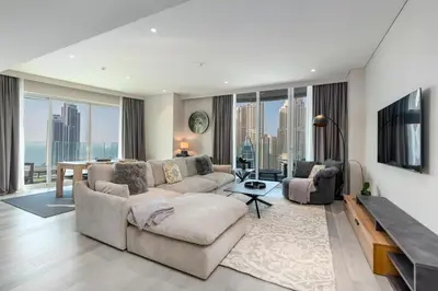 a living room with a couch and a table at BLVD - Direct Marina Walk - Eye of Dubai Fireworks - Iconic Marina Views with Rooftop Pool in Dubai