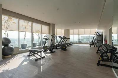 a gym with a bunch of treadmills and machines at BLVD - Direct Marina Walk - Eye of Dubai Fireworks - Iconic Marina Views with Rooftop Pool in Dubai