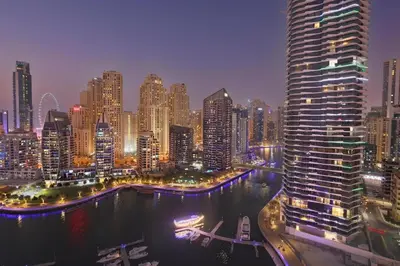 a view of a city at night with a large building at BLVD - Direct Marina Walk - Eye of Dubai Fireworks - Iconic Marina Views with Rooftop Pool in Dubai