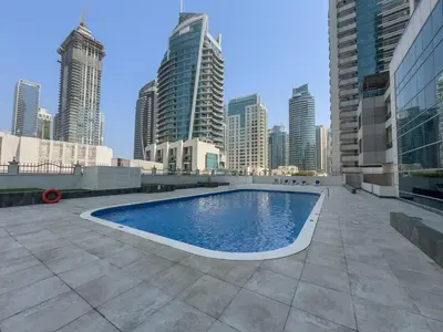 a swimming pool on the roof of a building with a city at Vogue Marina Diamond Near JBR Beach and Marina Mall, One Bedroom Apartment with Balcony and City View, Access to all Amenities, Walkable to Sobha Realty Metro Station and Bus Stop in Dubai