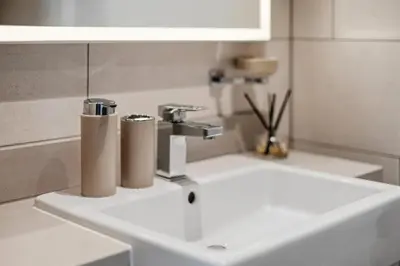 a bathroom sink with two paper rolls on it at Sobha Hartland, Green building2 1BR in Dubai
