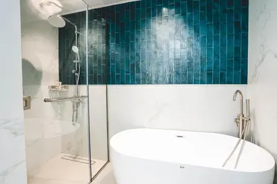 a bathroom with a tub and a glass shower at Penthouse on 74th Floor 3 Bedrooms Palm Views in Dubai