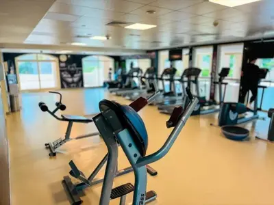 a gym with a row of exercise bikes at Bright & Spacious 2BR Apartment | The Greens Community in Dubai