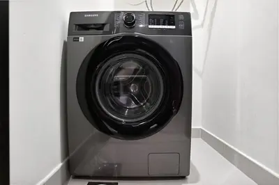 a washing machine is sitting in a room at Lux 1BR & Steps to Dubai Mall & Burj Khalifa in Dubai