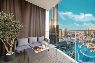 a living room with a couch and a view of a city at Luxury 4BR Burj View Steps from Dubai Mall in Dubai