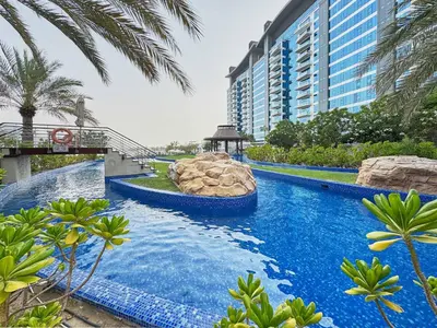 a large swimming pool with a water slide in a resort at Palm Jumeirah Oasis - Stylish 1 Bedroom Apartment with Garden, Pool & private Beach Access in Dubai