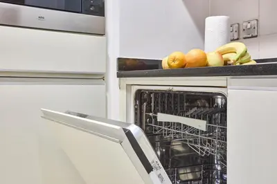 a dish rack in an oven with fruit in it at Palm Jumeirah Oasis - Stylish 1 Bedroom Apartment with Garden, Pool & private Beach Access in Dubai