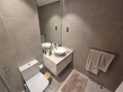 a bathroom with a toilet and a sink and a mirror at Modern one bedroom in marina in Dubai