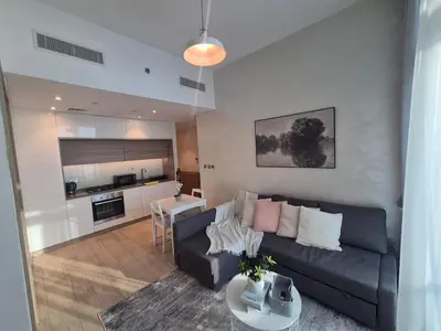 a living room with a couch and a table at Modern one bedroom in marina in Dubai