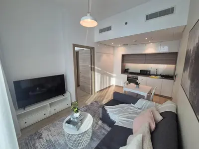 a living room with a couch and a flat screen tv at Modern one bedroom in marina in Dubai