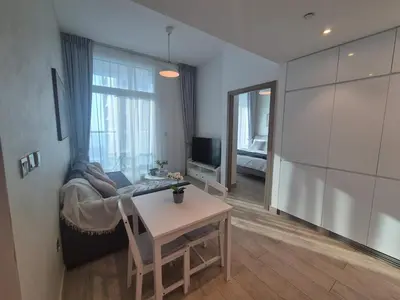 a living room with a table and a couch at Modern one bedroom in marina in Dubai