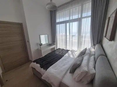 a bedroom with a bed and a large window at Modern one bedroom in marina in Dubai