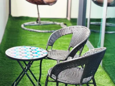 three chairs and a table and a table and chairs at Bright & Cozy 1BR in Business Bay with Skyline Views in Dubai