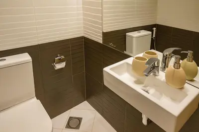 a bathroom with a sink and a toilet at Luxury 1BR with Marina Views Swimming Pool Gym in Dubai