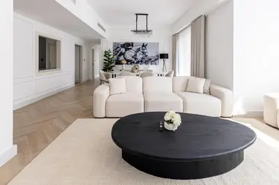 a living room with a black table and a couch at Amazing 2 bedroom with Sea view ! Rimal ! in Dubai