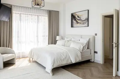 a white bedroom with a bed and a window at Amazing 2 bedroom with Sea view ! Rimal ! in Dubai