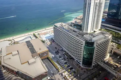 an aerial view of a tall building next to the ocean at Amazing 2 bedroom with Sea view ! Rimal ! in Dubai