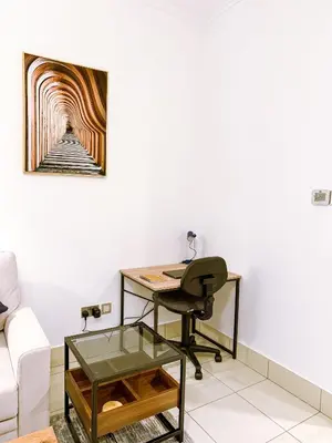 an office with a desk and a chair at Premium1BR Retreat with Burj Khalifa View in Dubai
