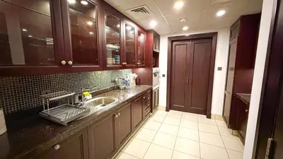 a kitchen with a sink and a counter top at Premium1BR Retreat with Burj Khalifa View in Dubai