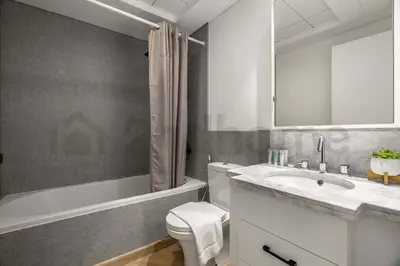 a bathroom with a toilet and a sink and a tub at Burj Khalifa View - New Furnished Unit in Downtown in Dubai