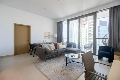 a living room with a couch and a table at Downtown Views 2BR-Direct Dubai Mall Connection in Dubai