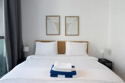 a bedroom with a bed with two towels on it at Downtown Views 2BR-Direct Dubai Mall Connection in Dubai