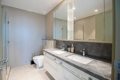 a bathroom with two sinks and a toilet at Downtown Views 2BR-Direct Dubai Mall Connection in Dubai