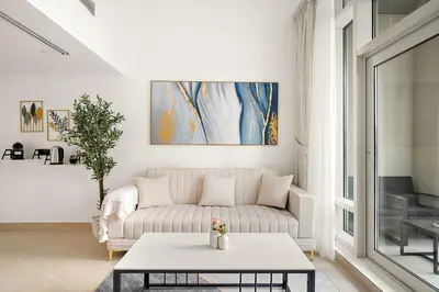 a living room with a couch and a table at FIRST CLASS 2BR Modern Comfort in the City in Dubai