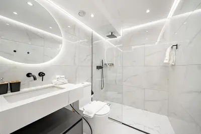 a bathroom with a shower and a toilet and a sink at FIRST CLASS 2BR Modern Comfort in the City in Dubai