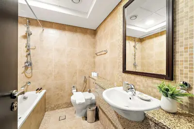 a bathroom with a sink and a toilet and a mirror at Silkhaus Comfy Studio in Sky Gardens with DIFC Views in Dubai